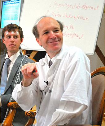 06 DSC_2399 cropped corrected.jpg - Dr Travis beams at the graphics display as he points with his laser pen. Raja Peter described Dr Travis as the world's leading researcher in his field of electroencephalography and praised his captivating and warm-hearted presentations.